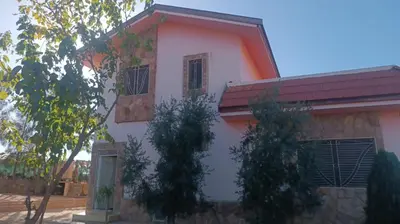 a pink house with a red roof at dar hammouni