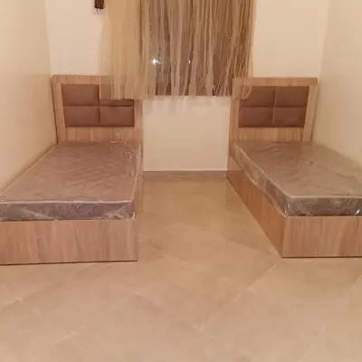 two beds sitting in a room with at dar hammouni