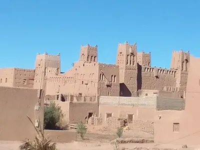 a large building in the middle of the desert at Dar dmana chez l'habitant in Skoura