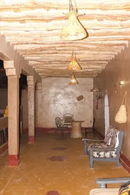 a room with chairs and a table in a building at Dar dmana chez l'habitant in Skoura