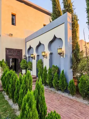 a building with a bunch of trees in front of it at Dar Muskana
