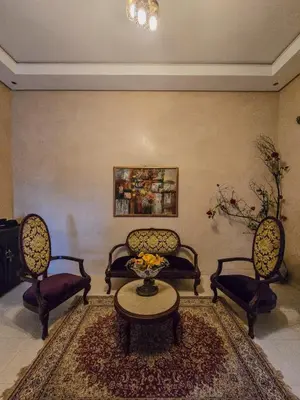 a living room with chairs and a table in a room at Dar Muskana