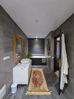 a bathroom with a sink and a bath tub at Dar Muskana