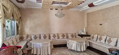 a living room with a couch and two tables at Villa in Meknès