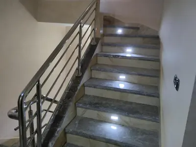 a set of stairs with metal railing in a building at Villa in Meknès