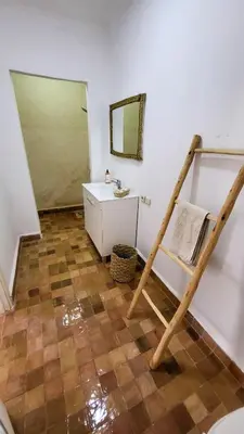 a bathroom with a ladder and a sink and a mirror at Tawenza Lodge in Aït Ourir