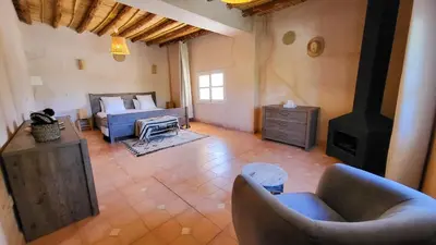 a living room with a couch and a stove at Tawenza Lodge in Aït Ourir