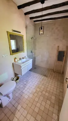 a bathroom with a toilet and a sink and a mirror at Tawenza Lodge in Aït Ourir