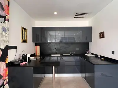 a kitchen with black cabinets and a black counter top at Villa Fiori Luxury Italian Villa, Pool & Spa, Marrakech in Douar bel Rhanodour