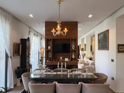 a living room with a chandelier and a table and chairs at Villa Fiori Luxury Italian Villa, Pool & Spa, Marrakech in Douar bel Rhanodour