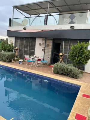 a house with a swimming pool in front of a house at Villa 2 houses, pool, nature view