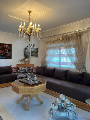a living room with a couch and a table at Villa 2 houses, pool, nature view