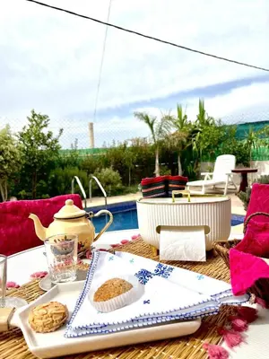 a table with a tea pot and cookies on it at Villa 2 houses, pool, nature view