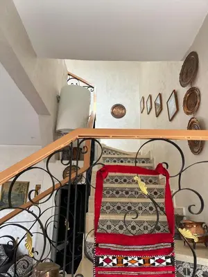 a room with a staircase with a red and black blanket at Villa 2 houses, pool, nature view