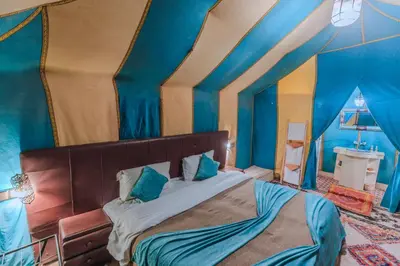 a bedroom with a bed in a blue room at Merzouga Desert Dome camp Erg Chebbi in Merzouga