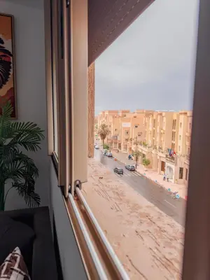 a view of a city street from a window at Fib Houses in Ouarzazate