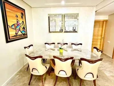 a dining room with a table and chairs at Reda's Apparts centre ville wifi 200 Mo in Fès