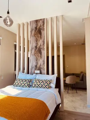 a bedroom with a large bed with pillows on it at Relax Family ApartHotel - Signature Residence in Ouarzazate