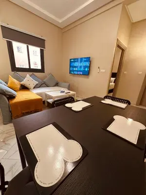 a living room with a table and a couch at Relax Family ApartHotel - Signature Residence in Ouarzazate