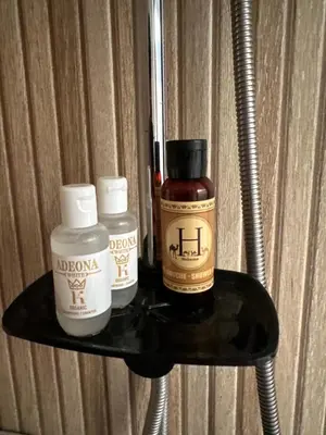 a shelf with three bottles of alcohol on it at Relax Family ApartHotel - Signature Residence in Ouarzazate