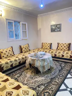 a living room with two beds and a table at Bedroom in medina in Fès