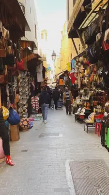 a group of people walking through a market at Bedroom in medina in Fès