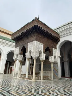 a courtyard of a building with a tile floor at Bedroom in medina in Fès