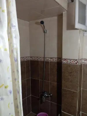 a shower with a shower head in a bathroom at Bedroom in medina in Fès