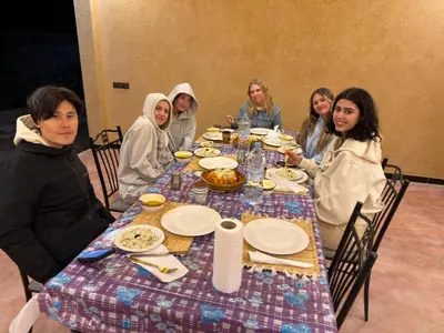 a group of women sitting around a table with food at dar olivegarden inn in Ait Sedrate Sahl Gharbia