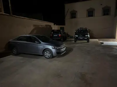 a silver car parked in a parking lot next to a building at dar olivegarden inn in Ait Sedrate Sahl Gharbia