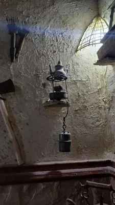 a metal tea kettle hanging from a wall at Gite ditabe tafoukte