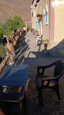 a blue bench sitting in front of a building at Gite ditabe tafoukte