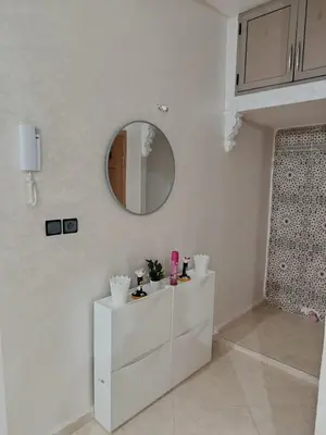 a white room with a mirror and a white dresser at Dar ARAHA in Fès