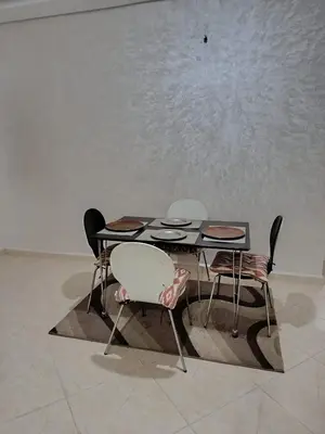three chairs and a table and a table and chairs at Dar ARAHA in Fès