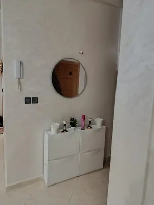 a white bathroom with a mirror and a white dresser at Dar ARAHA in Fès