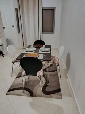 a dining room table with chairs and plates on it at Dar ARAHA in Fès