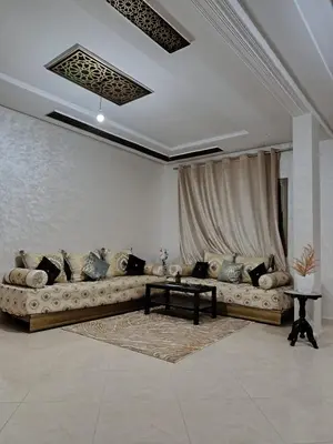 a living room with a couch and a table at Dar ARAHA in Fès