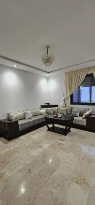 a living room with a couch and a table at Agadir bay in Oulad Akkou