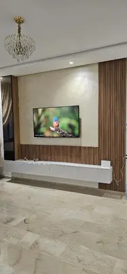 a living room with a tv on a wall at Agadir bay in Oulad Akkou
