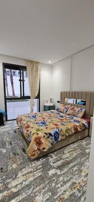 a bedroom with a large bed with a colorful blanket at Agadir bay in Oulad Akkou