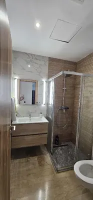 a bathroom with a tub and a shower and a sink at Agadir bay in Oulad Akkou