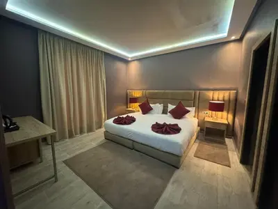 a bedroom with a bed with red pillows on it at RS Hôtel Karam Resort in Ouarzazate