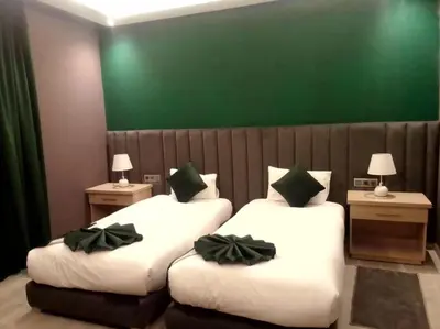 two beds in a hotel room with bows on them at RS Hôtel Karam Resort in Ouarzazate