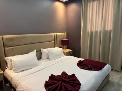 a bedroom with a large bed with red bows on it at RS Hôtel Karam Resort in Ouarzazate