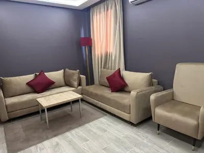 a living room with two couches and a table and two chairs at RS Hôtel Karam Resort in Ouarzazate