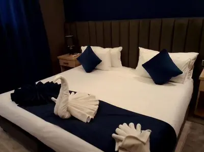 a bedroom with a bed with two stuffed animals on it at RS Hôtel Karam Resort in Ouarzazate