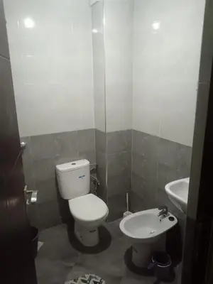 a bathroom with a toilet and a sink at Appart hôtel tanger in Oulad Akkou
