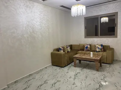 a living room with a couch and a table at Al basatine in Meknès