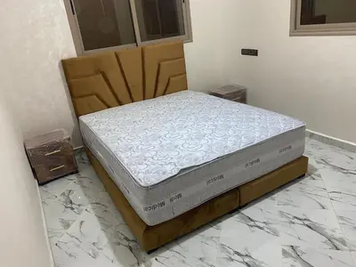a mattress sitting on a bed frame in a room at Al basatine in Meknès