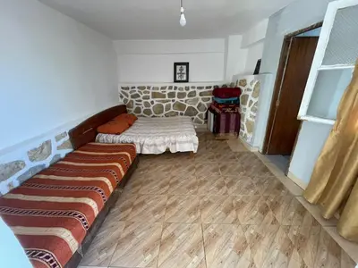 a living room with a couch in the corner at Boulemane guest house in Boulmane